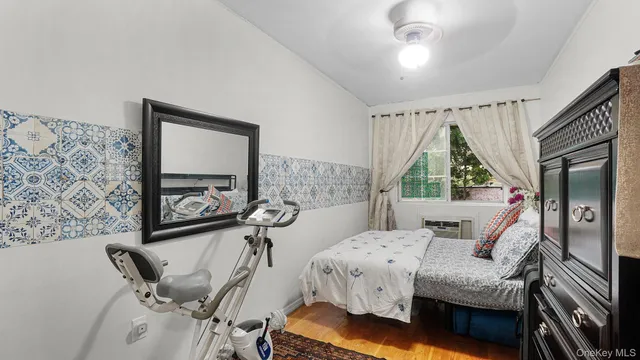 a bedroom with a bed and small cabinets