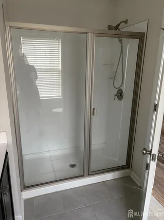 a bathroom with a glass door shower