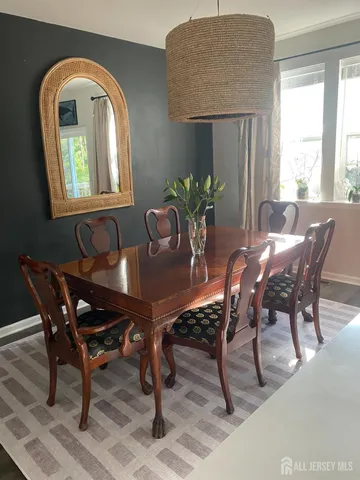 a dining room with furniture and window