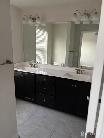 a bathroom with a sink double vanity and a mirror