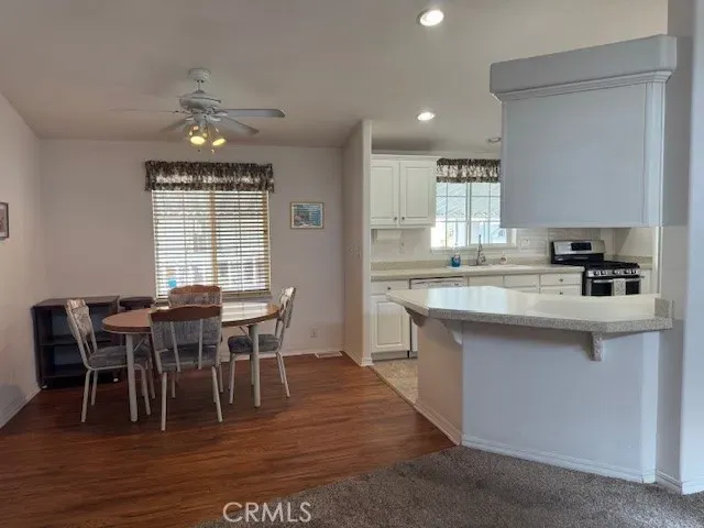 a view of a dining room with furniture and wooden floor