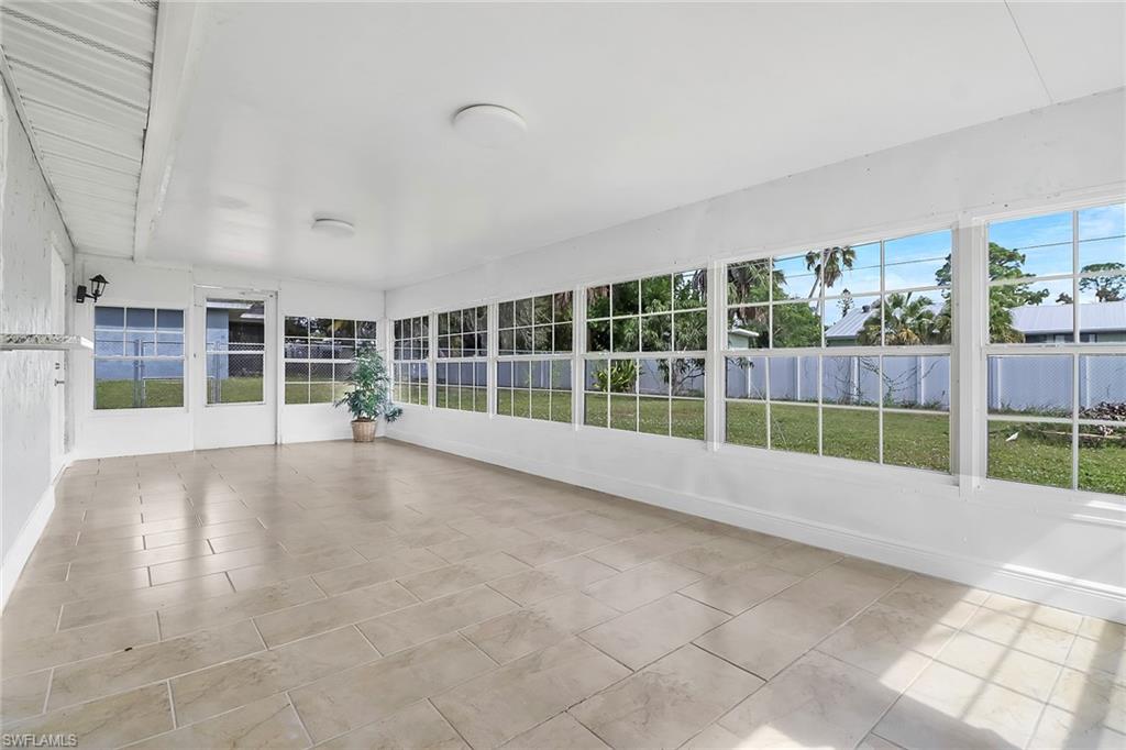 18659 Sarasota Road Fort Myers, FL 33967 - Photo 18 of 19 a view of an empty room with wooden floor and a window