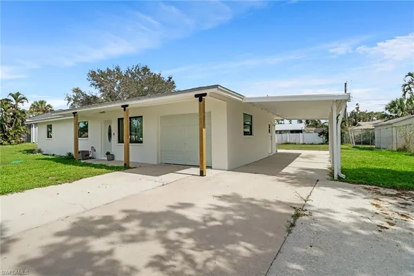 a view of a parking space in front of a house