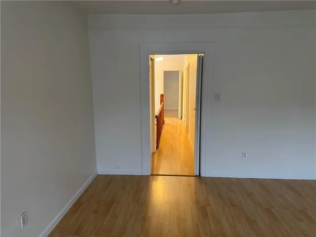 a view of room with hardwood floor and window