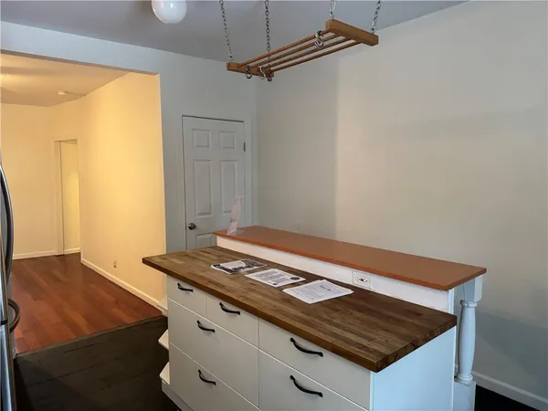 a kitchen with a sink refrigerator and window