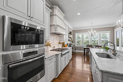 a kitchen with sink stove and cabinets