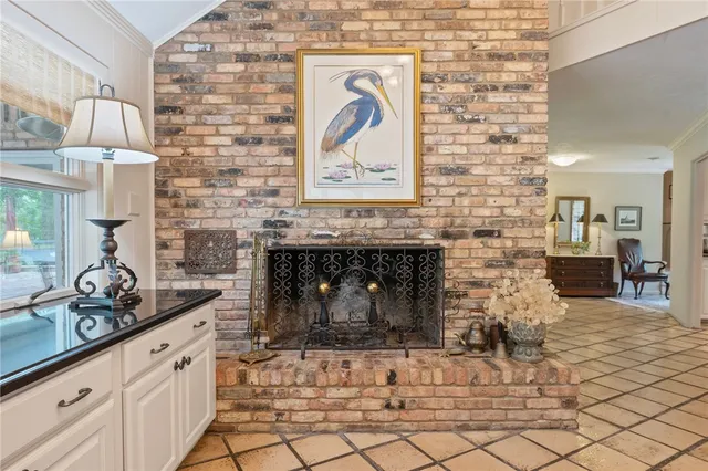 a kitchen with a fireplace and cabinets