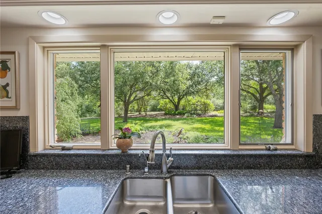 a kitchen with a sink and large window