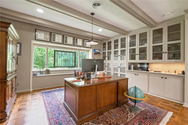 a work space with granite countertop furniture and a large window