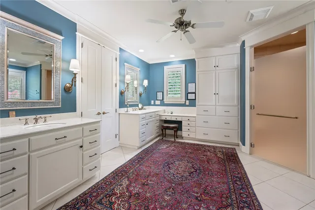 a large white kitchen with a sink and a refrigerator