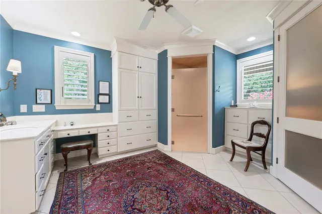 a spacious bedroom with a bed a desk and chair