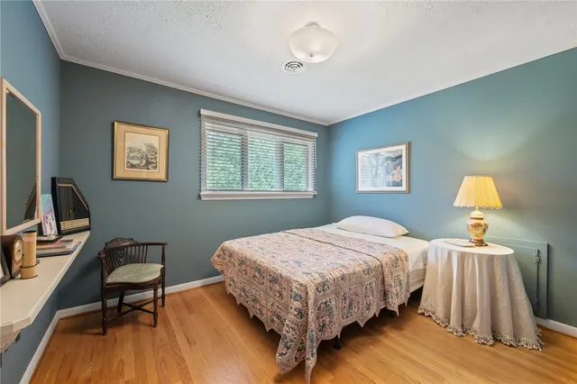 a bedroom with a bed a desk and chair