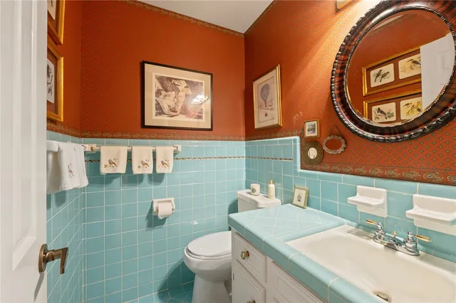 a bathroom with a sink a mirror and a toilet