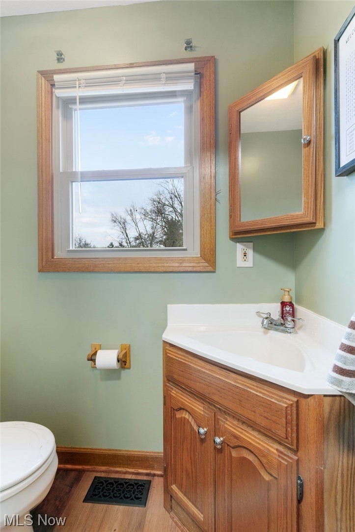 4915 Monticello Street Northwest Canton, OH 44708 - Photo 17 of 31 Bathroom with toilet, vanity, and wood-type flooring