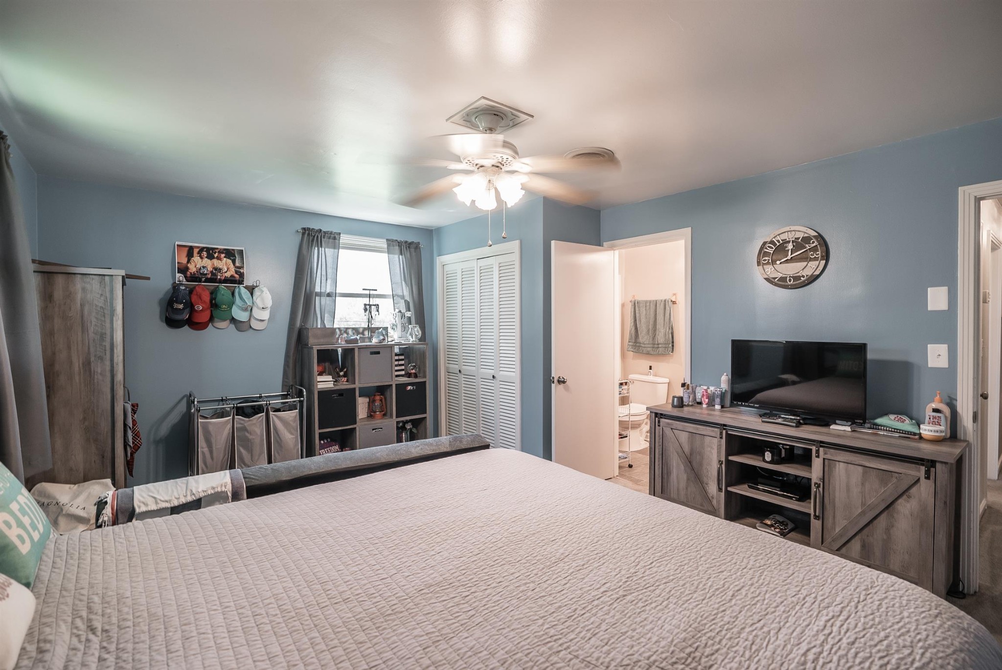 6842 Bethel Road Greenbrier, TN 37073 - Photo 19 of 30 a bedroom with a bed and a flat screen tv