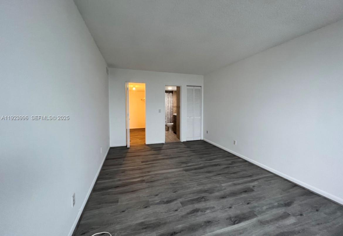 13499 Biscayne Boulevard, Unit 1205 North Miami, FL 33181 - Photo 15 of 32 a view of a hallway with wooden floor and closet