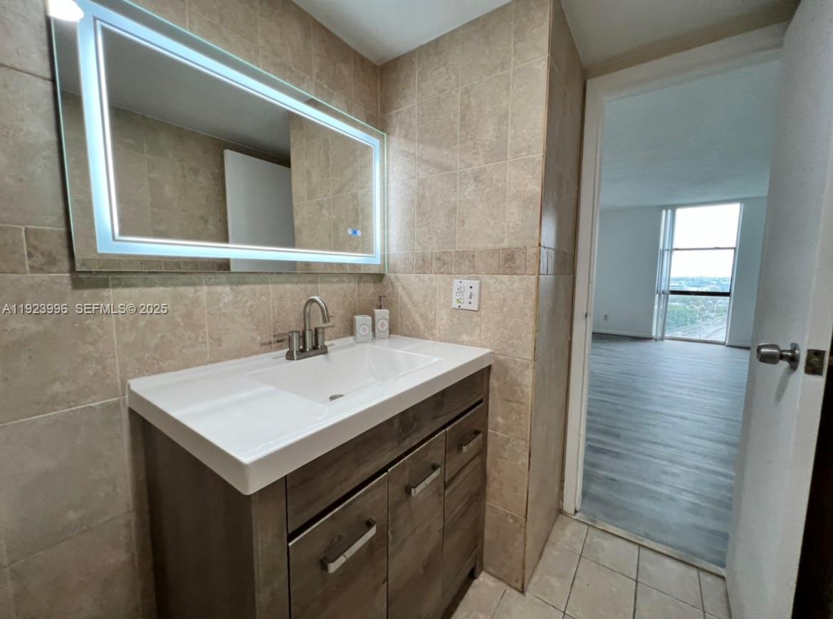 13499 Biscayne Boulevard, Unit 1205 North Miami, FL 33181 - Photo 19 of 32 a bathroom with a sink and a mirror