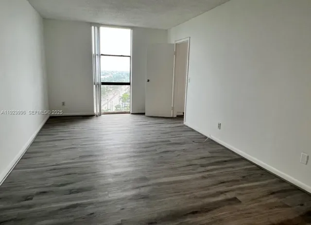 a view of wooden floor and windows in a room