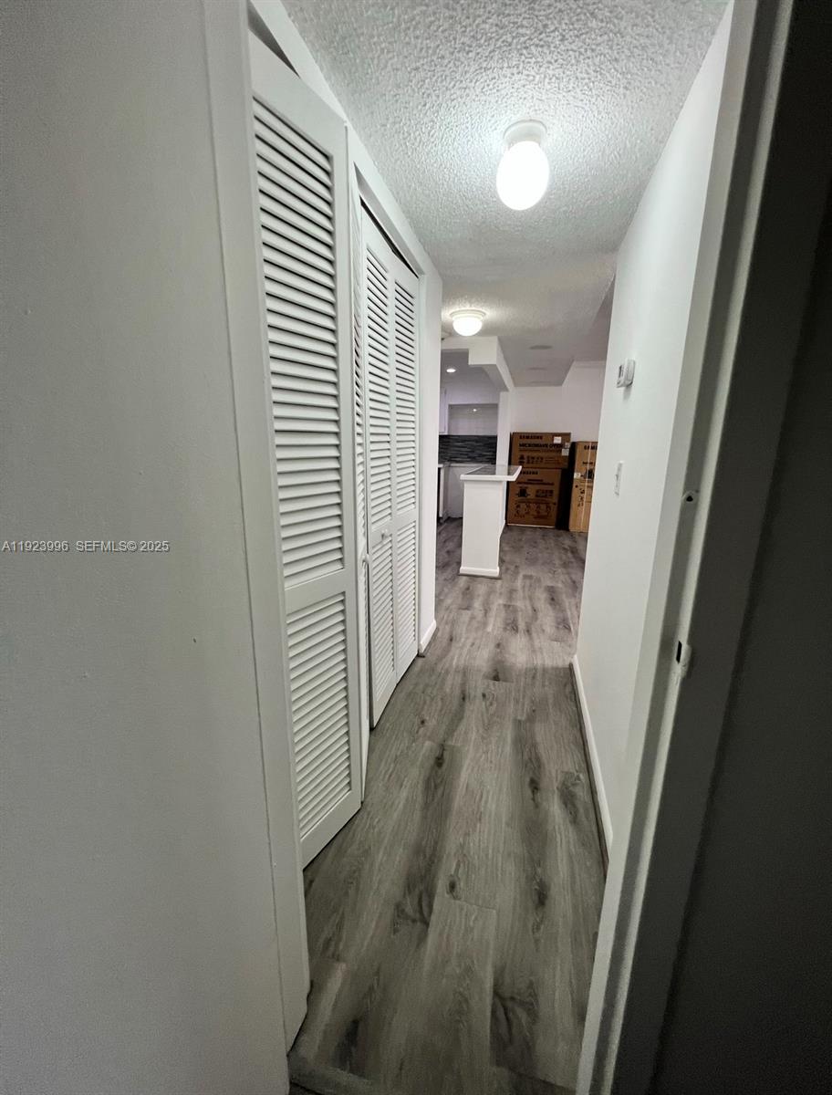 13499 Biscayne Boulevard, Unit 1205 North Miami, FL 33181 - Photo 31 of 32 a view of a hallway with wooden floor and staircase