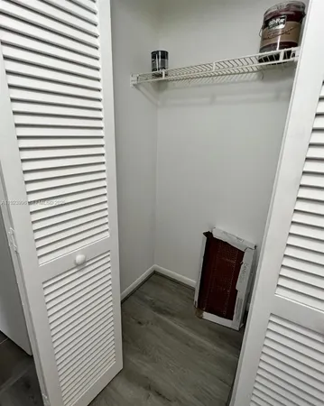 a view of a room with wooden floor