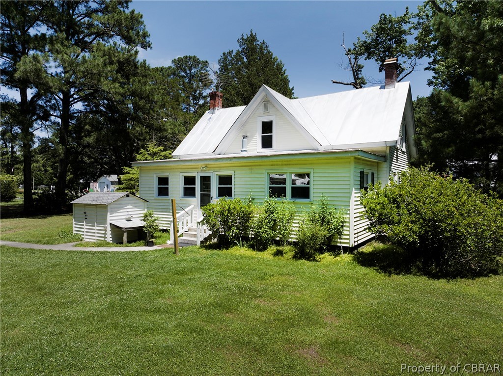 2442 Old Ferry Road Hudgins, VA 23076 - Photo 24 of 33 Back of house with a yard and a shed