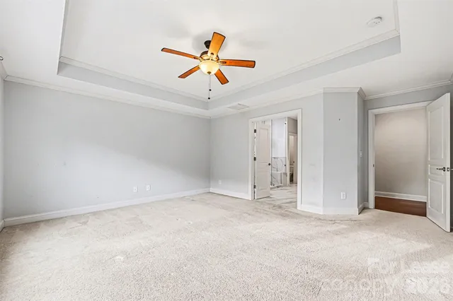 an empty room with closet and windows