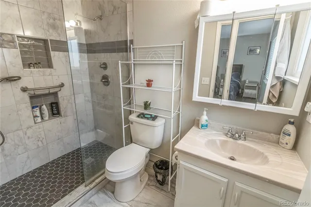 a bathroom with a sink toilet and shower