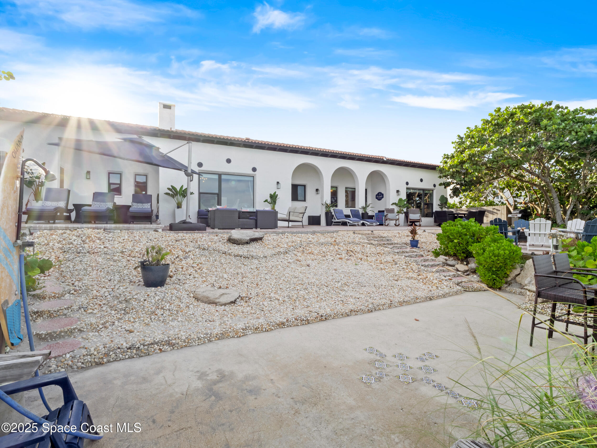 933 South Atlantic Avenue Cocoa Beach, FL 32931 - Photo 11 of 46 a view of a yard with a house in the background