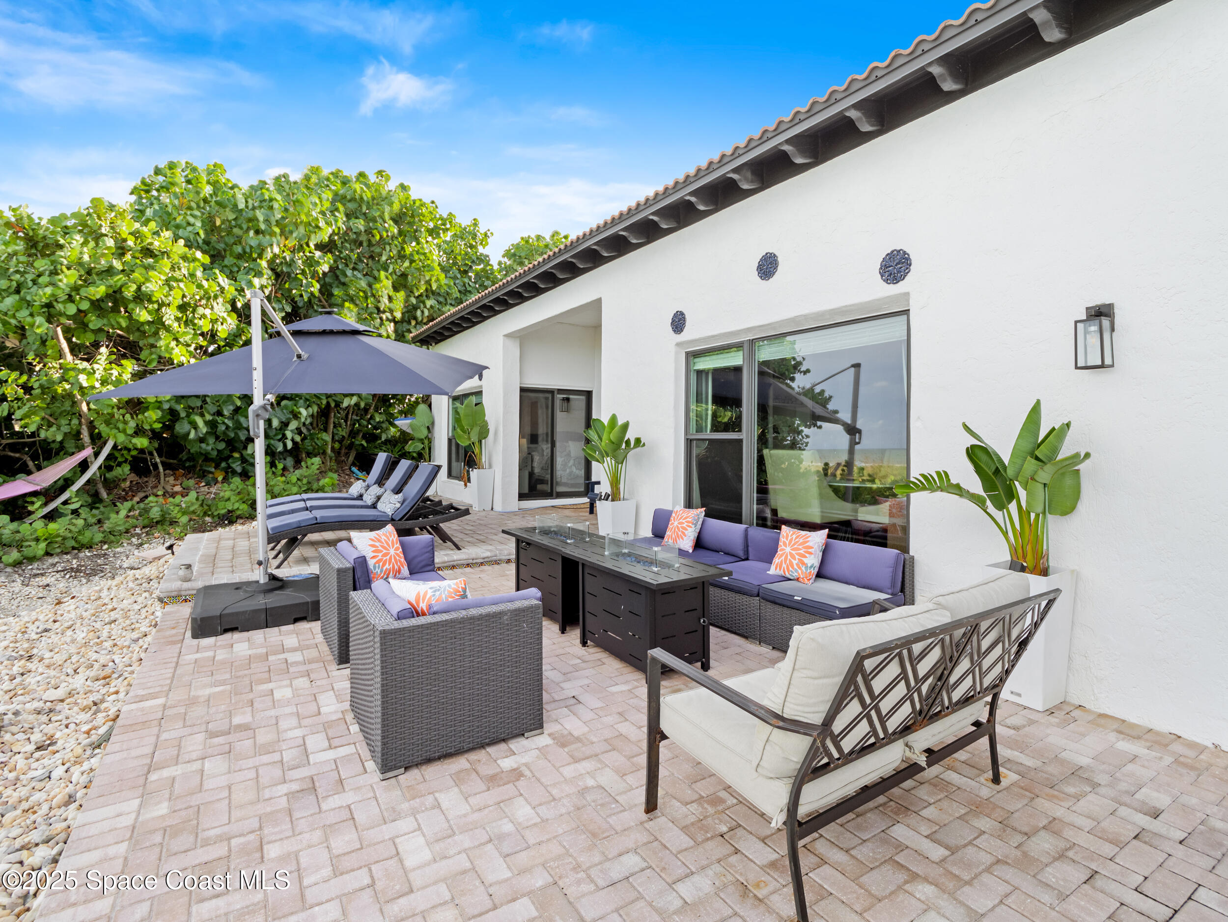 933 South Atlantic Avenue Cocoa Beach, FL 32931 - Photo 12 of 46 a view of a patio with couches and a potted plant
