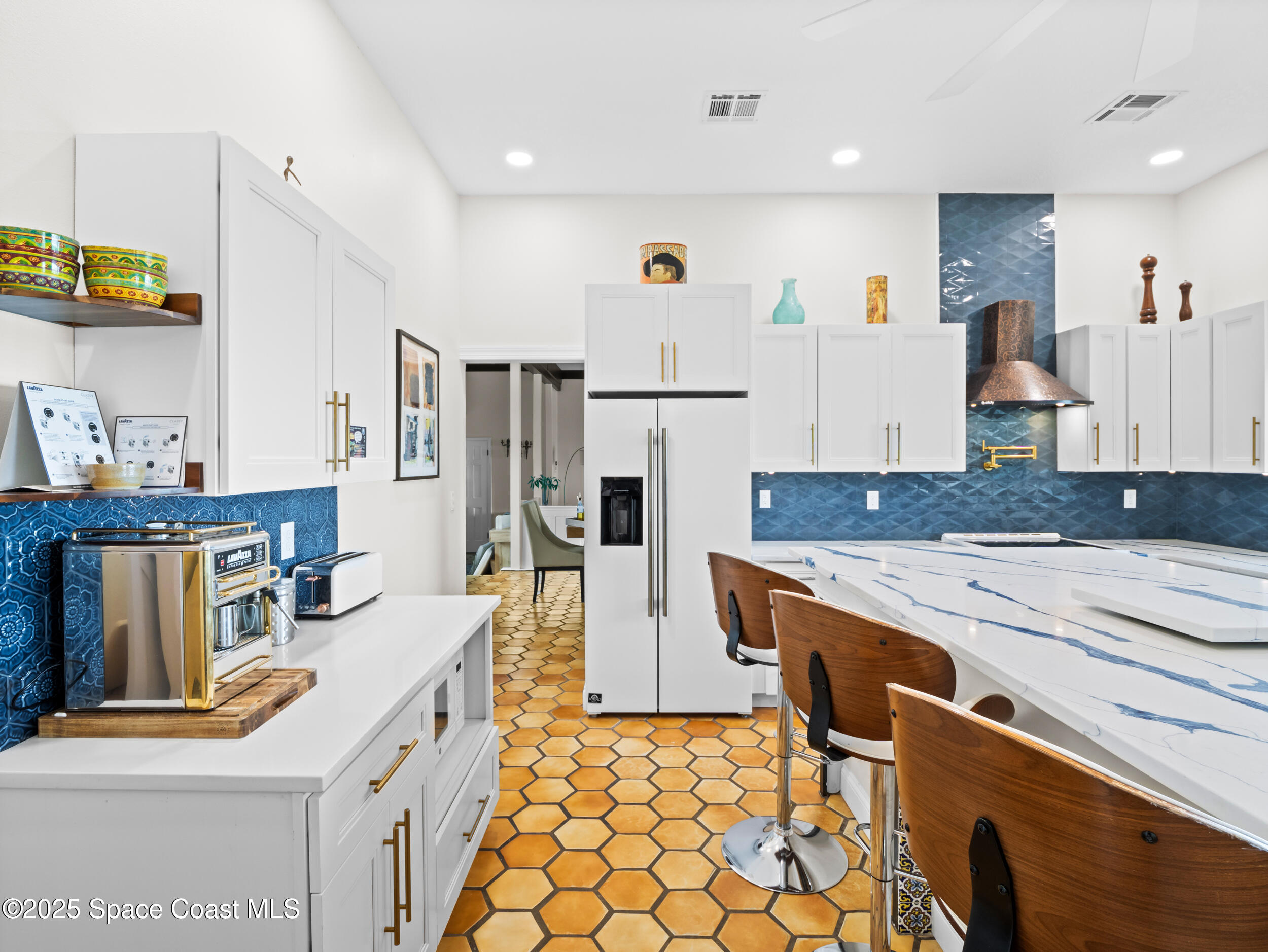 933 South Atlantic Avenue Cocoa Beach, FL 32931 - Photo 15 of 46 a kitchen with stainless steel appliances granite countertop a sink and a refrigerator