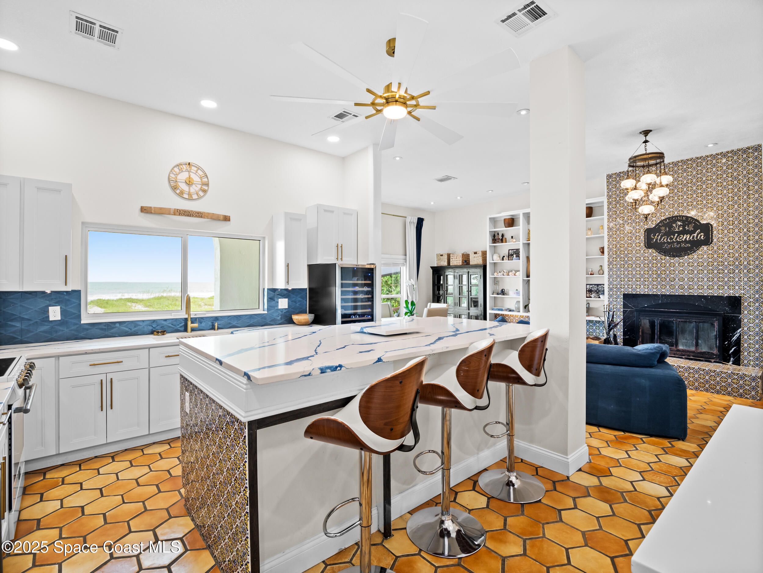 933 South Atlantic Avenue Cocoa Beach, FL 32931 - Photo 16 of 46 a kitchen with stainless steel appliances granite countertop a sink a stove a dining table and chairs