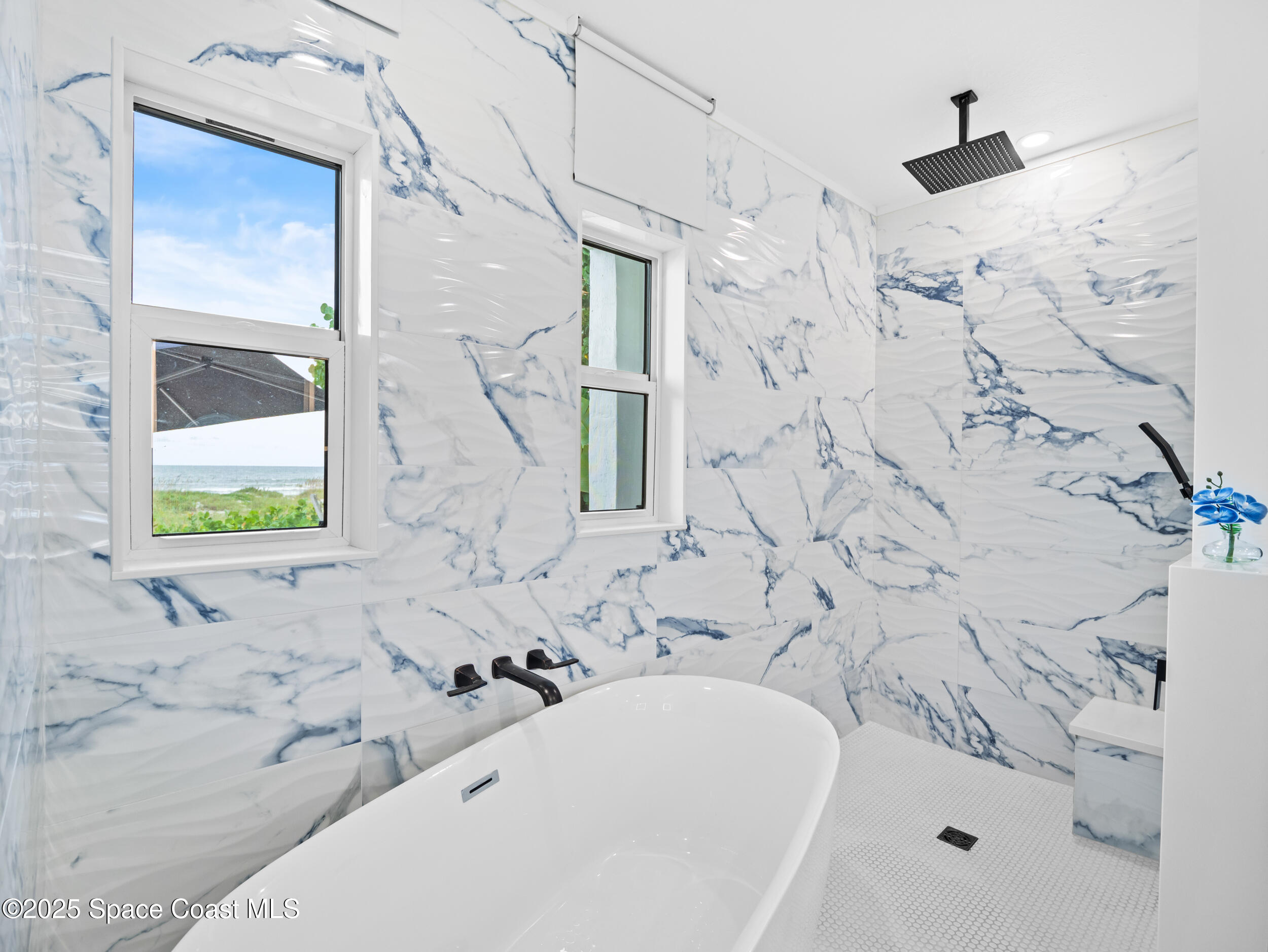 933 South Atlantic Avenue Cocoa Beach, FL 32931 - Photo 20 of 46 a bathroom with shower bathtub and sink