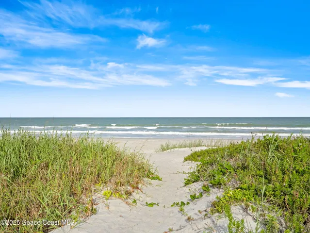an aerial view of a house with garden space and lake view