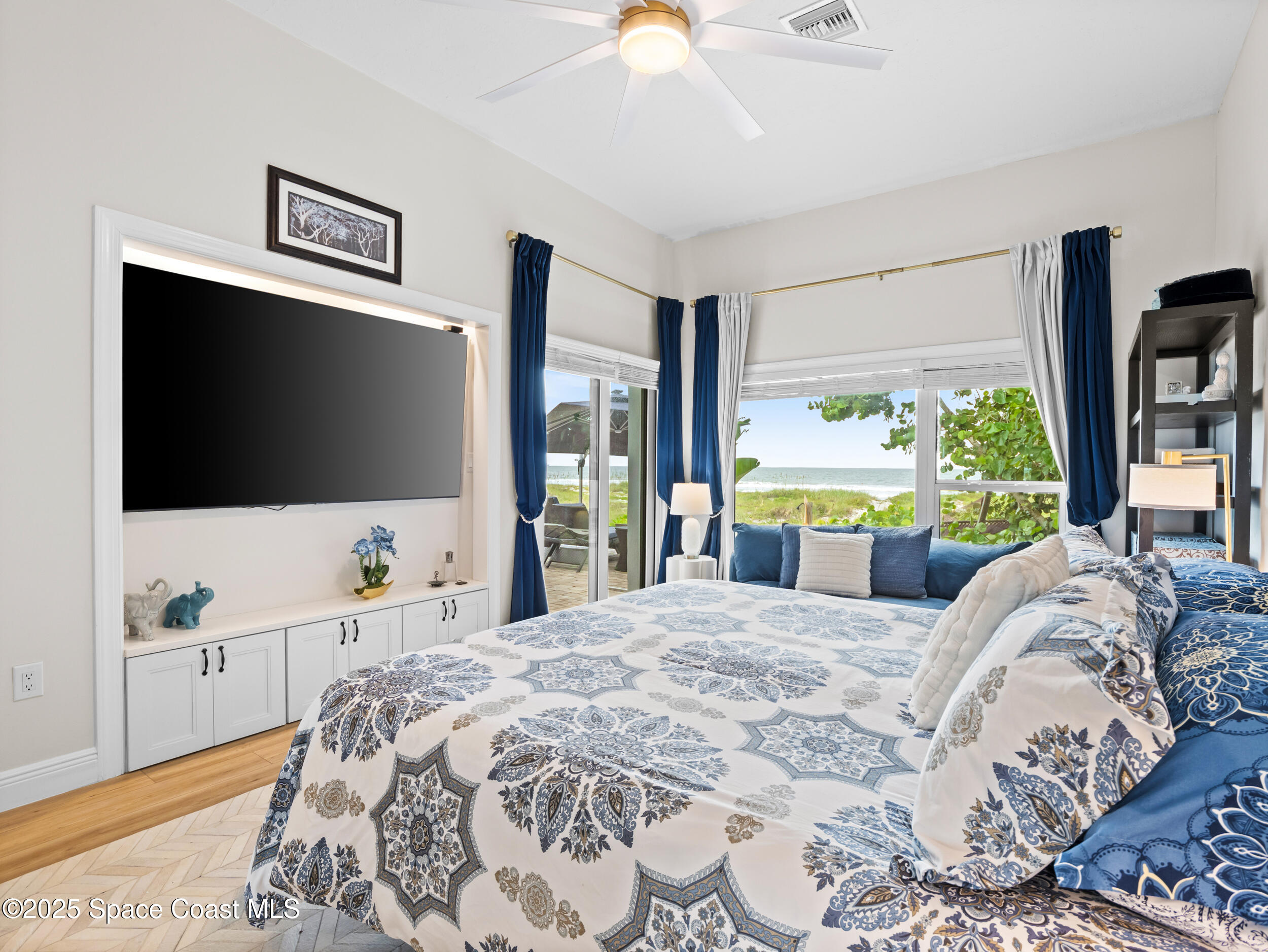 933 South Atlantic Avenue Cocoa Beach, FL 32931 - Photo 23 of 46 a bedroom with a bed and a flat screen tv on the dresser