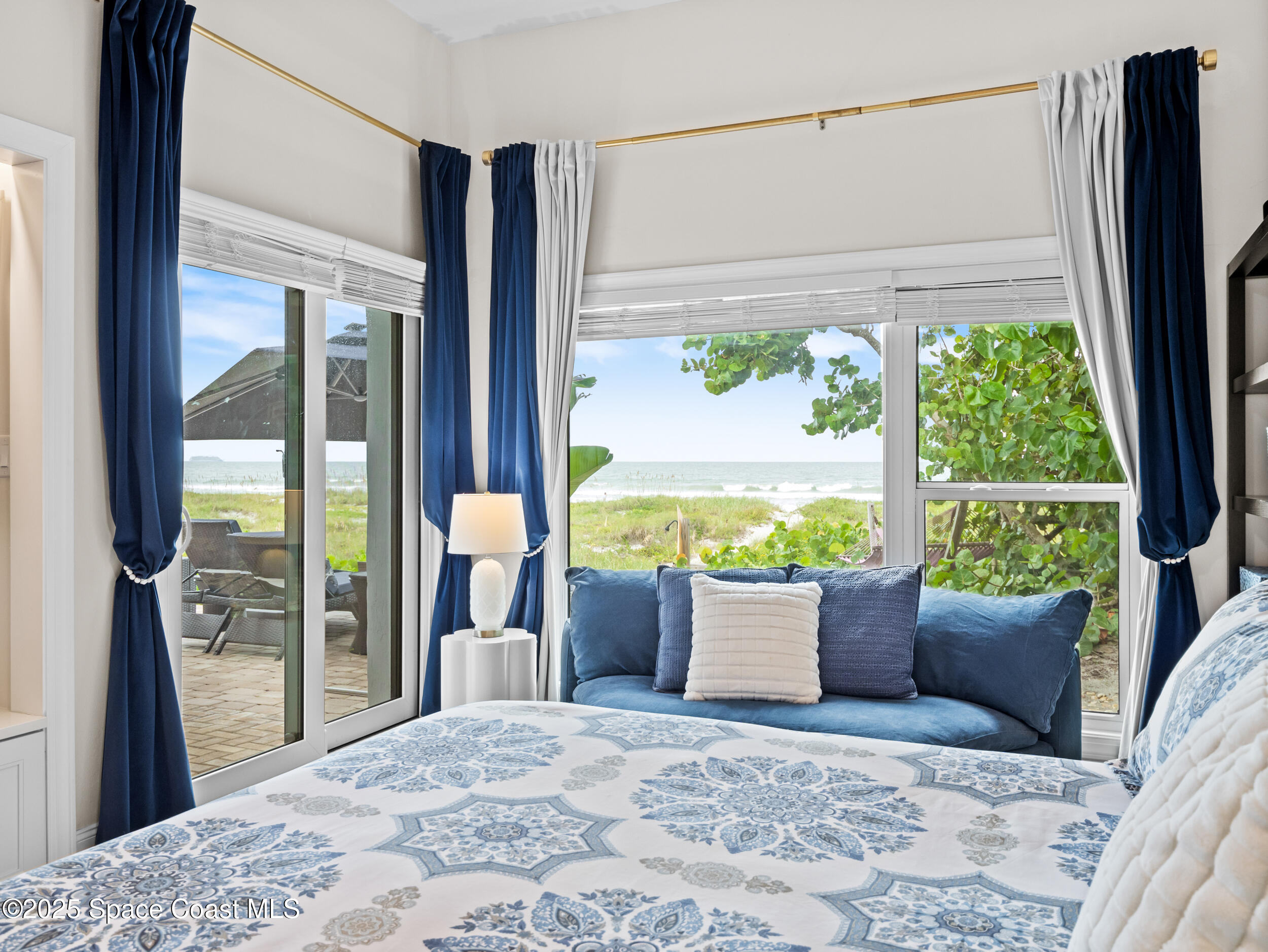 933 South Atlantic Avenue Cocoa Beach, FL 32931 - Photo 25 of 46 a bed sitting in a bedroom next to a window