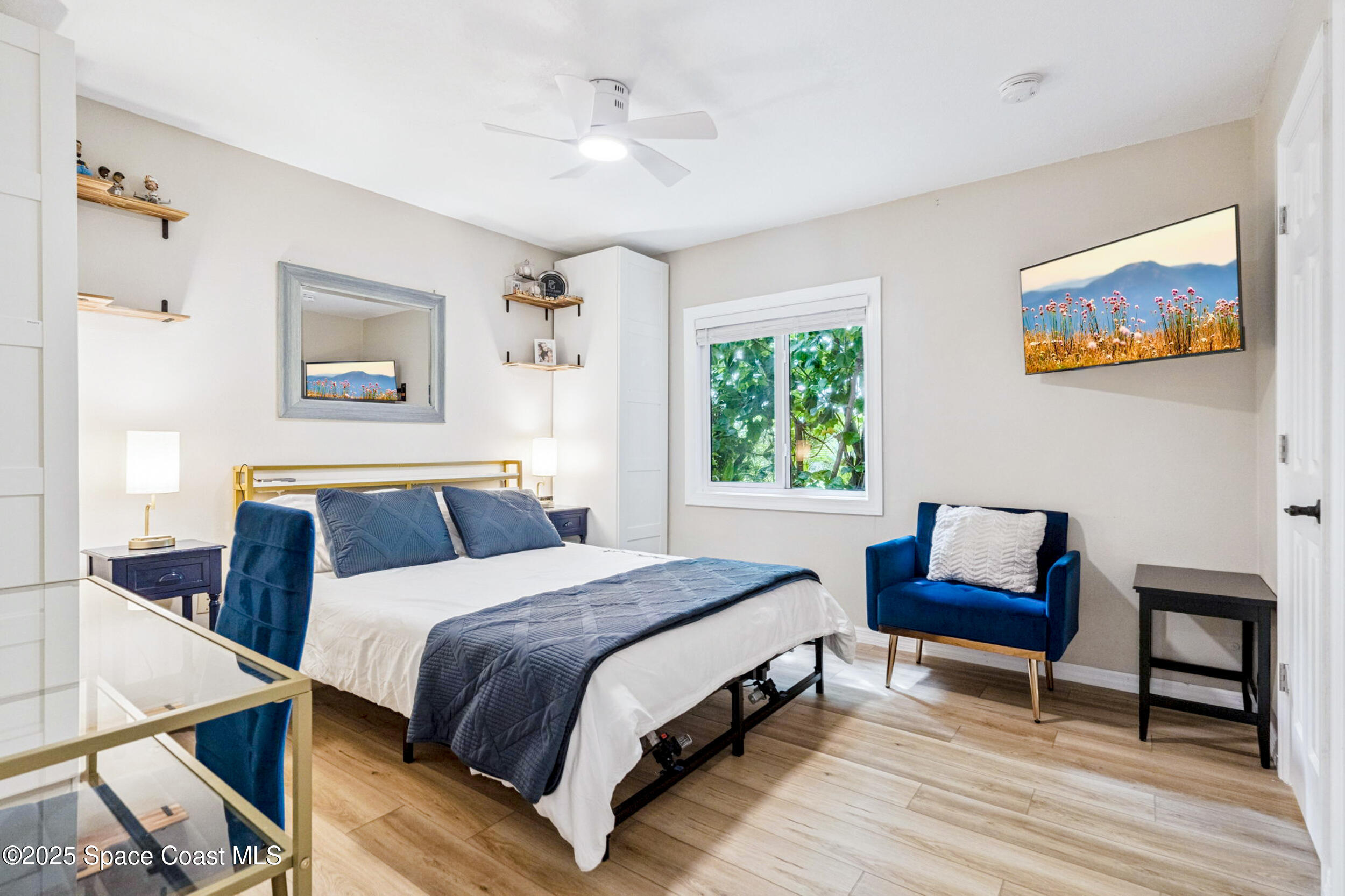 933 South Atlantic Avenue Cocoa Beach, FL 32931 - Photo 37 of 46 a bedroom with a bed and a chair