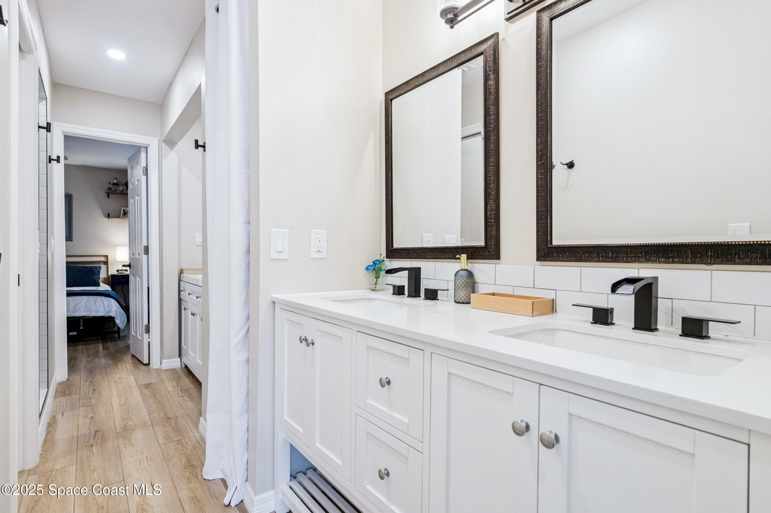933 South Atlantic Avenue Cocoa Beach, FL 32931 - Photo 38 of 46 a bathroom with a double vanity sink and mirror