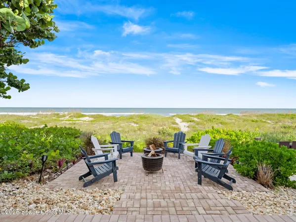 a view of an outdoor sitting area with furniture and umbrella