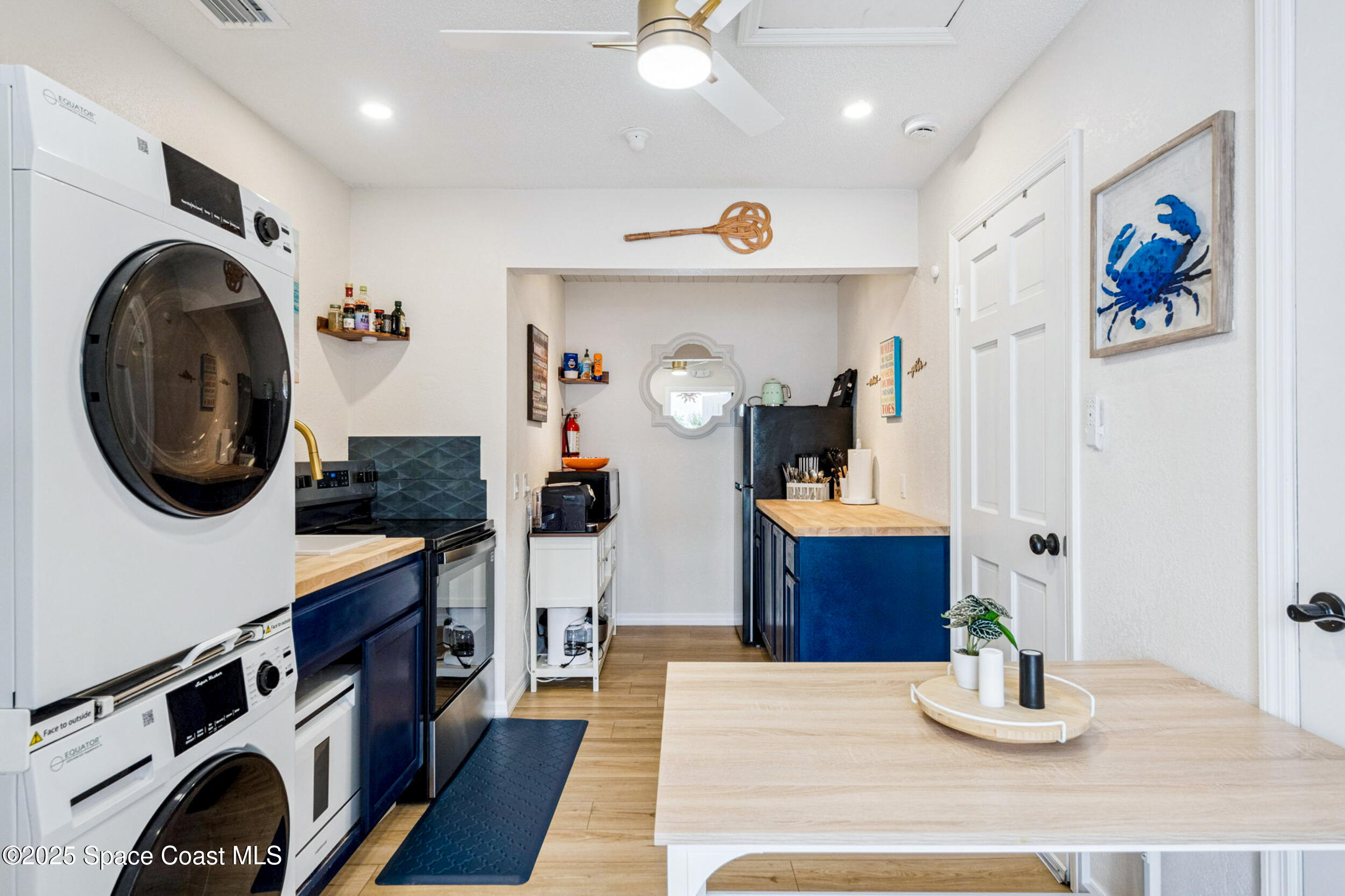 933 South Atlantic Avenue Cocoa Beach, FL 32931 - Photo 42 of 46 a kitchen with stainless steel appliances granite countertop a stove and a wooden floors