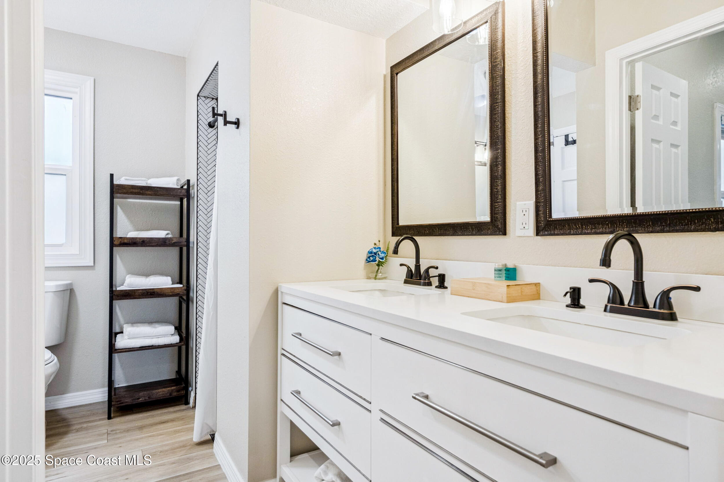 933 South Atlantic Avenue Cocoa Beach, FL 32931 - Photo 43 of 46 a bathroom with a sink and a mirror