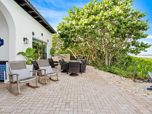 a kitchen with stainless steel appliances granite countertop a sink a stove a dining table and chairs