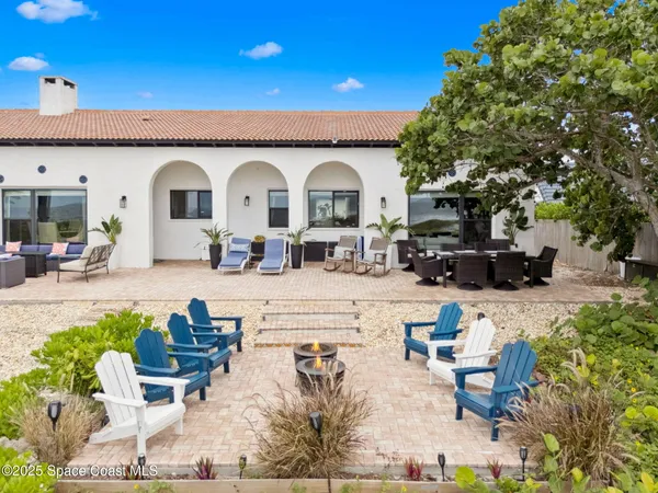 a dining room with furniture and a floor to ceiling window