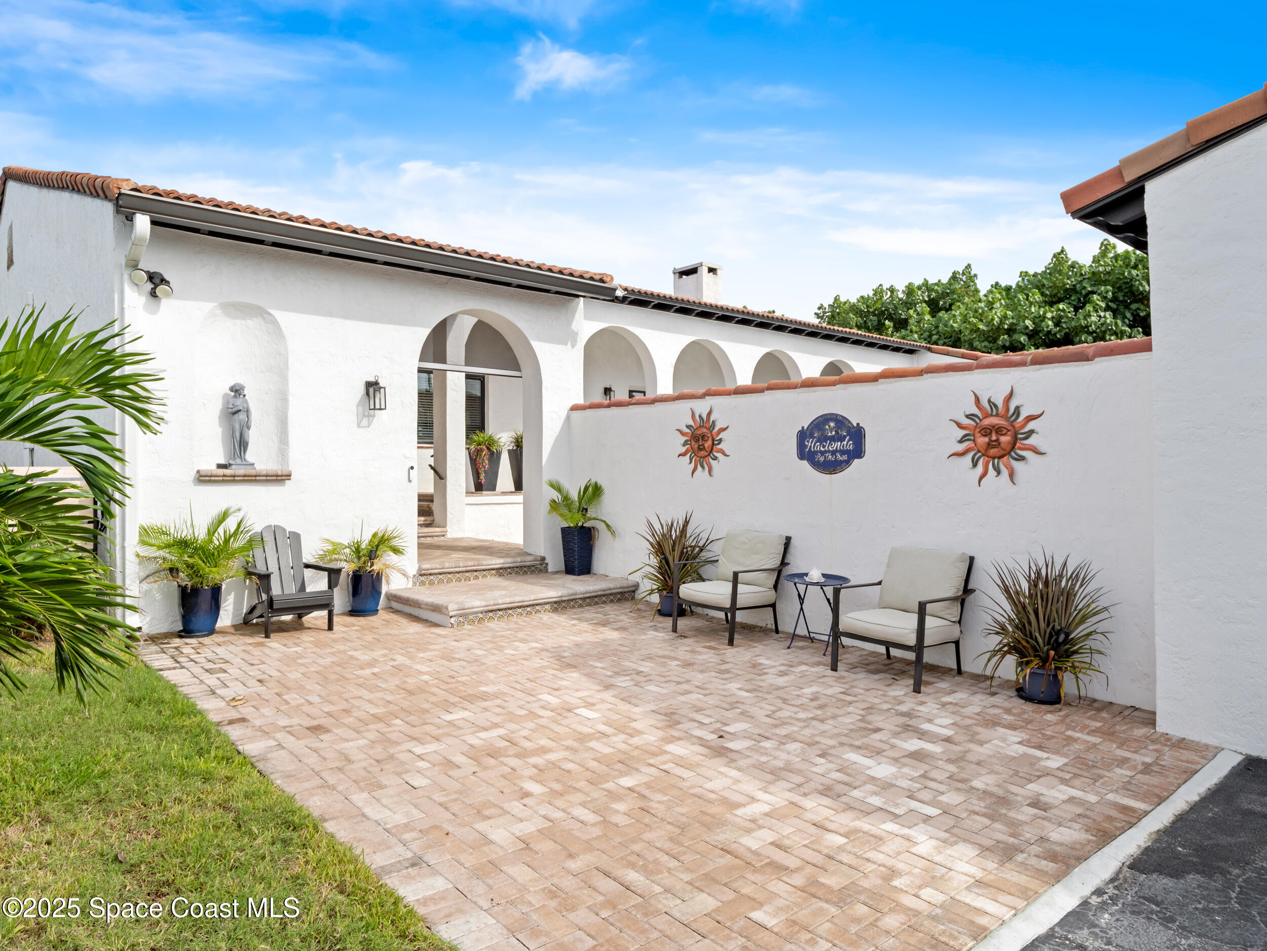 933 South Atlantic Avenue Cocoa Beach, FL 32931 - Photo 8 of 46 a front view of a house with patio