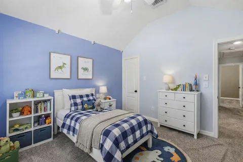 a bedroom with a bed and a night stand