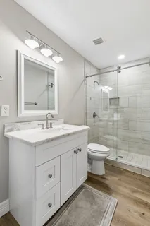 an aerial view of a house with a yard and lake view