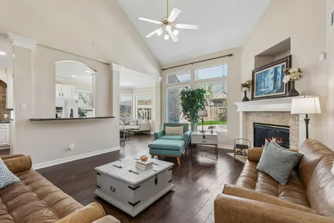 a kitchen with granite countertop cabinets stainless steel appliances a sink and wooden floor