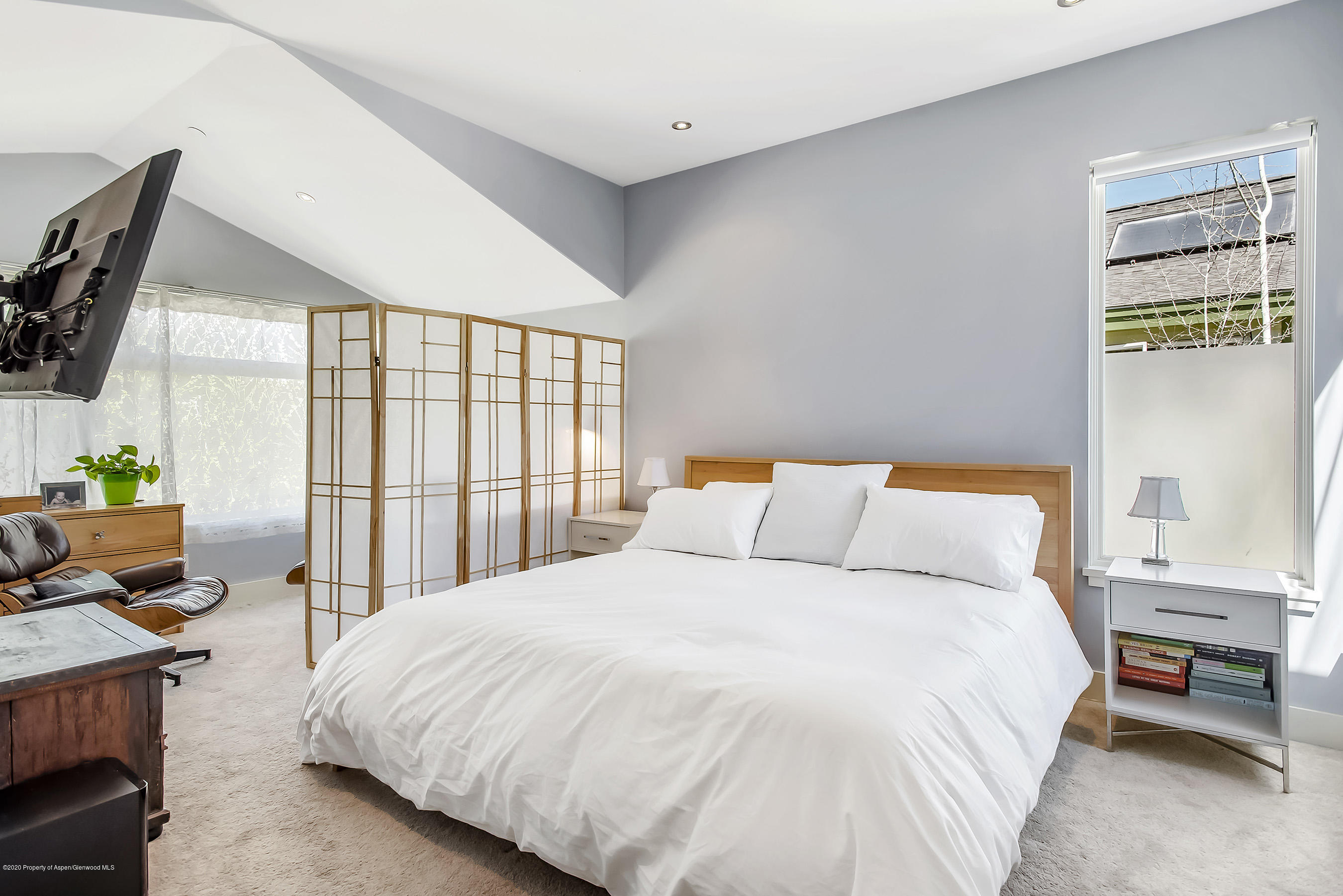 80 Riverdown Drive Aspen, CO 81611 - Photo 13 of 31 a bedroom with a bed a large window and flat screen tv