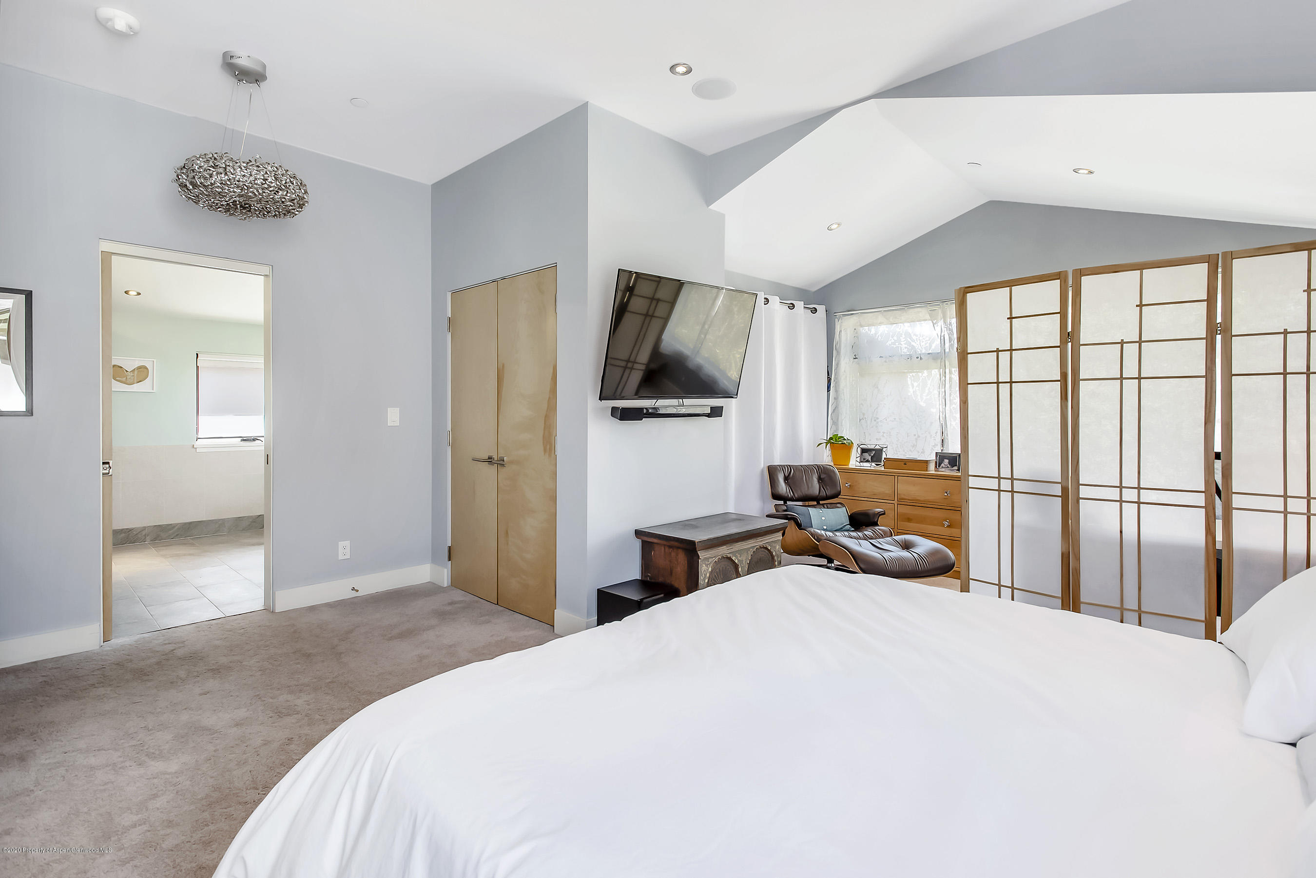 80 Riverdown Drive Aspen, CO 81611 - Photo 14 of 31 a bedroom with a bed and a flat tv screen