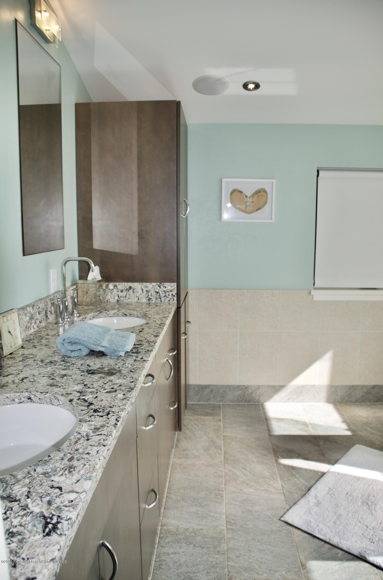 80 Riverdown Drive Aspen, CO 81611 - Photo 17 of 31 a bathroom with a granite countertop sink and a mirror