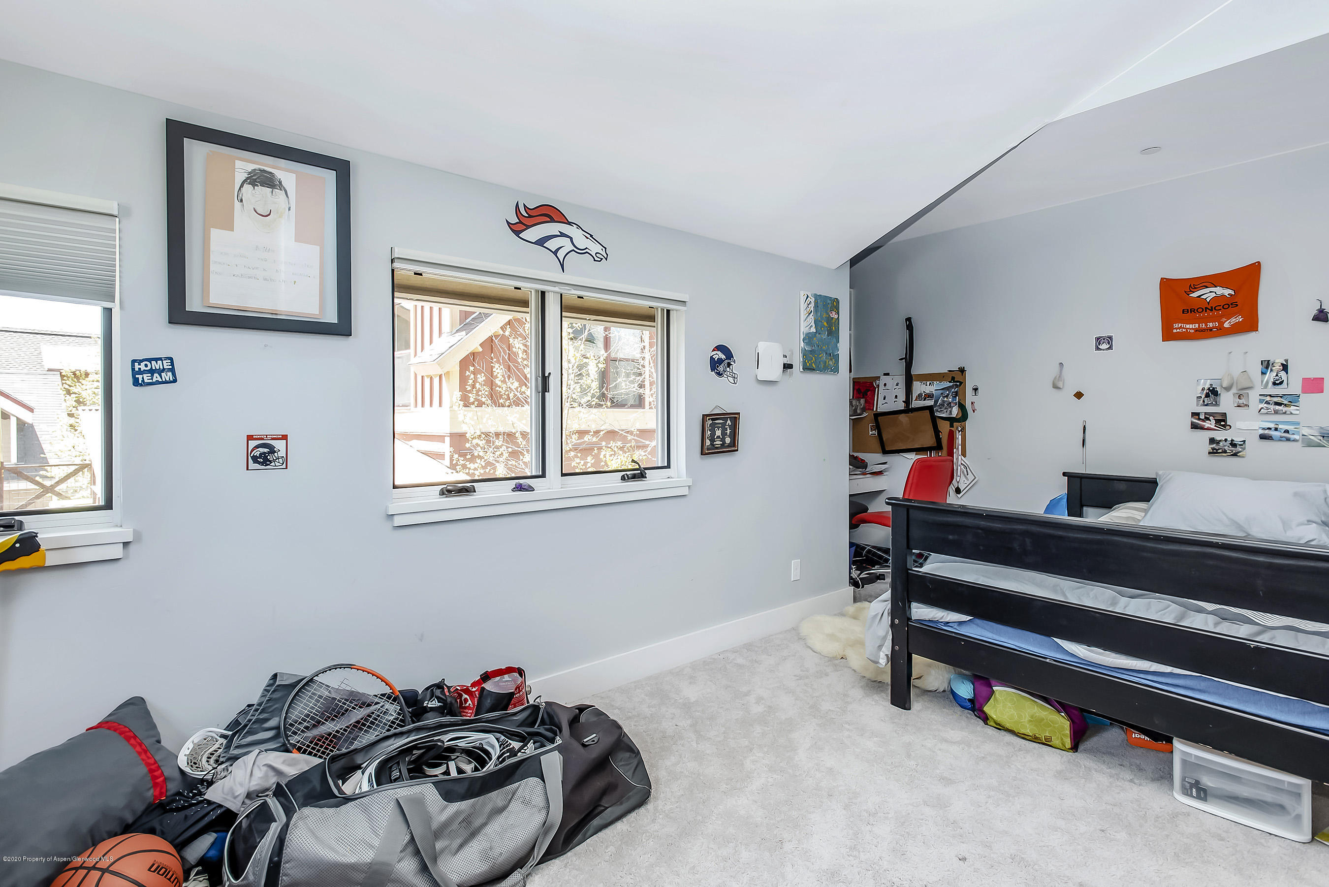 80 Riverdown Drive Aspen, CO 81611 - Photo 19 of 31 a bedroom with bed and a window